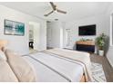 Bright main bedroom with carpet, ceiling fan, TV, and backyard access at 20075 E Kestrel St, Queen Creek, AZ 85142