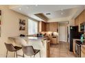 Functional kitchen boasts wooden cabinets, a breakfast bar, and modern appliances for everyday convenience at 2055 W Jasper Butte Dr, Queen Creek, AZ 85144