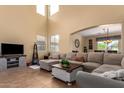 Bright living room features high ceilings, neutral tones, and a large comfortable sectional sofa at 2055 W Jasper Butte Dr, Queen Creek, AZ 85144