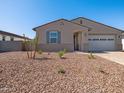 A charming single-story home with a two-car garage, neutral stucco exterior, and low-maintenance desert landscaping at 24493 W Grenadine Rd, Buckeye, AZ 85326