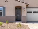 Close-up of the home's front door with a charming walkway and desert landscaping, offering curb appeal at 24493 W Grenadine Rd, Buckeye, AZ 85326