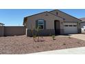 Attractive single-story home features desert landscaping, inviting entryway, and a convenient two-car garage at 24493 W Grenadine Rd, Buckeye, AZ 85326