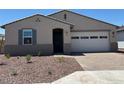 Inviting single-story home with a well-maintained front yard, brick paver driveway, and attached garage for two cars at 24493 W Grenadine Rd, Buckeye, AZ 85326