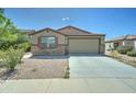 Charming single-story home featuring a two-car garage and low maintenance desert landscaping with stone accents at 25755 W Hazel Dr, Buckeye, AZ 85326