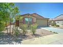 Charming single-story home featuring a two-car garage and low maintenance desert landscaping with stone accents at 25755 W Hazel Dr, Buckeye, AZ 85326