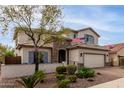 Charming two-story home with a manicured lawn and attached two-car garage at 2605 W Golden Puma Trl, Phoenix, AZ 85085