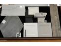 Interior design sample board exhibiting cabinet, countertop, tile, and flooring options at 26079 S 228Th St, Queen Creek, AZ 85142