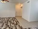 Bright, open-concept living area featuring durable flooring, fresh white paint, and ample natural light from windows at 3330 S Gilbert Rd # 1003, Chandler, AZ 85286