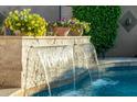 Beautiful pool with stone waterfall feature, perfect for relaxation and outdoor enjoyment at 3921 W Sheffield Ave, Chandler, AZ 85226