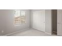 Bright bedroom with a window, closet, neutral paint, and carpet flooring at 4119 S 176Th Dr, Goodyear, AZ 85338