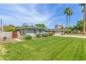 Beautifully landscaped front yard with lush green grass and mature trees at 4208 E Windsor Ave, Phoenix, AZ 85008