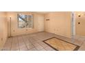 Living room showcasing tile flooring, and a large window providing natural light at 461 W Holmes Ave # 224, Mesa, AZ 85210