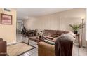 Open-concept living room with dining area, comfortable sofa and tile flooring at 461 W Holmes Ave # 224, Mesa, AZ 85210