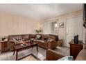 Cozy living room with comfortable seating, tiled floors, and a neutral color palette at 461 W Holmes Ave # 224, Mesa, AZ 85210