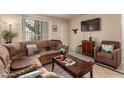 The living room features tile floors, a comfortable sofa, and modern television at 461 W Holmes Ave # 224, Mesa, AZ 85210