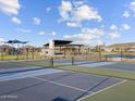 Community pickleball courts with blue and green surfaces, black fencing, and shaded picnic pavilion at 4813 N 177Th Ln, Goodyear, AZ 85395