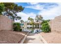 Scenic view of the lake access with pool and water views in a private community at 665 W Beechnut Dr, Chandler, AZ 85248