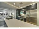 Contemporary kitchen featuring stainless steel appliances and open view to a modern living space at 7151 E Rancho Vista Dr # 3010, Scottsdale, AZ 85251