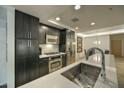 Well-lit kitchen with stainless steel appliances, sleek cabinets, and a countertop with an integrated sink at 7151 E Rancho Vista Dr # 3010, Scottsdale, AZ 85251