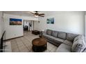 Inviting living room featuring tile flooring, a comfortable sofa and decor art at 811 E Seldon Ln, Phoenix, AZ 85020