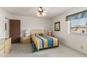 View of the bedroom showing a ceiling fan and a large window for natural light at 8315 E Lobo Ave, Mesa, AZ 85209
