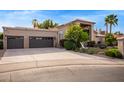 Spacious three-car garage and extended driveway with mature desert landscaping at 851 N Citrus Cove --, Mesa, AZ 85213