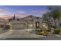 Inviting single-story home with desert landscaping and two-car garage offers suburban charm at 9733 W Hedge Hog Pl, Peoria, AZ 85383
