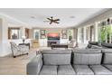 Cozy living room with a large gray sofa and ample natural light at 10749 E Nido Ave, Mesa, AZ 85209