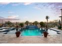 Large, luxurious pool with a spa and desert views with desert landscaping. Evening sky at 11457 E Salero Dr, Scottsdale, AZ 85262