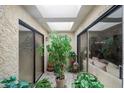 Bright atrium with natural light, sliding glass doors, and indoor plants, blending indoor comfort with nature at 5322 N 78Th St, Scottsdale, AZ 85250