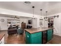 Open-concept kitchen with an eat-in island and mini fridge, seamlessly connected to the adjacent living room at 5410 E Duncan St, Mesa, AZ 85205