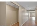 A bright hallway with wood-look flooring leads to another room with abundant natural light at 129 S 198Th Dr, Buckeye, AZ 85326