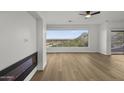 Bright living room offers a modern fireplace and oversized window with city views at 36 W Foothill Dr, Phoenix, AZ 85021
