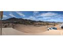 Expansive view of the property and desert landscape with surrounding mountain views in the background at 3835 W Fox Rd, Laveen, AZ 85339