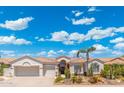 Inviting single-story home featuring a desert landscape, tile roof and attached two-car garage at 7722 E Hartford Dr, Scottsdale, AZ 85255