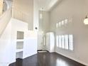 Bright entryway with a staircase, built-in shelving, and wood floors at 1237 E Marcella Ln, Gilbert, AZ 85295