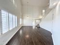 Spacious living room with soaring ceilings, wood floors, and ample natural light at 1237 E Marcella Ln, Gilbert, AZ 85295