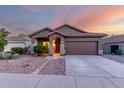 Charming single-story home with a well-manicured front yard, a two-car garage, and desert landscaping at 18217 E El Viejo Desierto --, Gold Canyon, AZ 85118