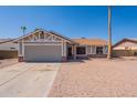 Inviting single-Gathering home features a two-car garage, low maintenance desert landscaping, and neutral color palette at 4906 E Evergreen St, Mesa, AZ 85205