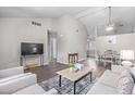 Open-concept living area with vaulted ceilings and views into the dining space at 5120 W Willow Ave, Glendale, AZ 85304