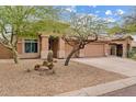 Charming single story home with a three car garage and desert landscaping at 10603 E Firewheel Dr, Scottsdale, AZ 85255