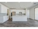 Bright kitchen featuring white cabinetry, stainless appliances, and a large island at 11996 N Luckenbach St, Surprise, AZ 85388