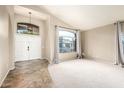 Bright open-concept living room featuring an arched entry, updated flooring, and a welcoming ambiance at 1447 E Nighthawk Way, Phoenix, AZ 85048
