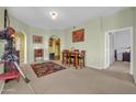 Cozy dining room with neutral walls, wooden dining set, and a view into adjacent rooms at 14575 W Mountain View Blvd # 11315, Surprise, AZ 85374