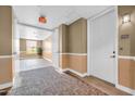 Hallway featuring apartment door with unit number and view of a well-lit sitting area at 14575 W Mountain View Blvd # 11315, Surprise, AZ 85374