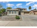 Beautiful two-story home with three-car garage and low-maintenance desert rock landscaping at 15138 W Campbell Ave, Goodyear, AZ 85395