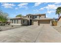 Lovely two-story home with desert landscaping, two-car garage, and barrel tile roof at 15138 W Campbell Ave, Goodyear, AZ 85395