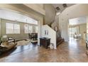 Inviting home foyer with a staircase and views of the dining and living rooms at 15138 W Campbell Ave, Goodyear, AZ 85395