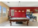 This game room offers a pool table and pinball machines, providing entertainment for all at 16158 W Christy Dr, Surprise, AZ 85379
