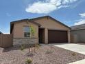 Charming single-story home features a two-car garage and well-maintained landscaping at 17433 W Eva St, Waddell, AZ 85355